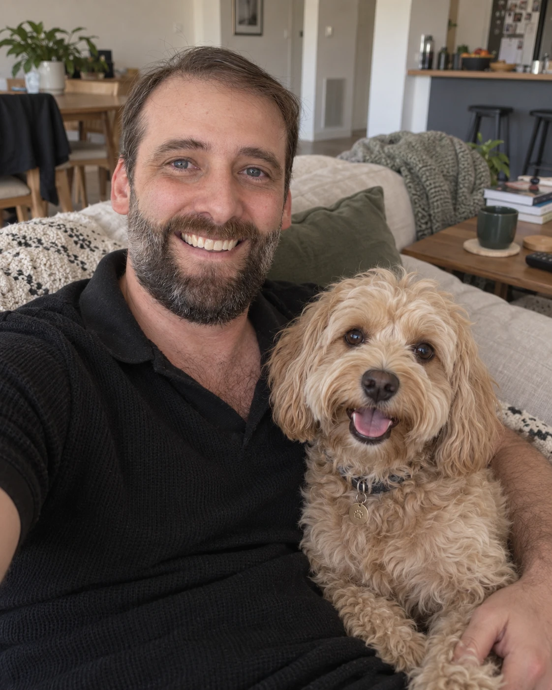 After: the same client smiling on the couch with his dog